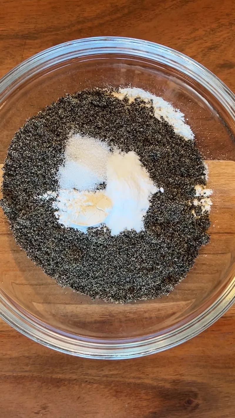 Dry ingredients — flour, black sesame powder, salt, baking powder, and baking soda — combined in a glass mixing bowl