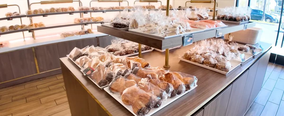Rows of wrapped pastries and buns on display shelves inside 85°C Bakery
