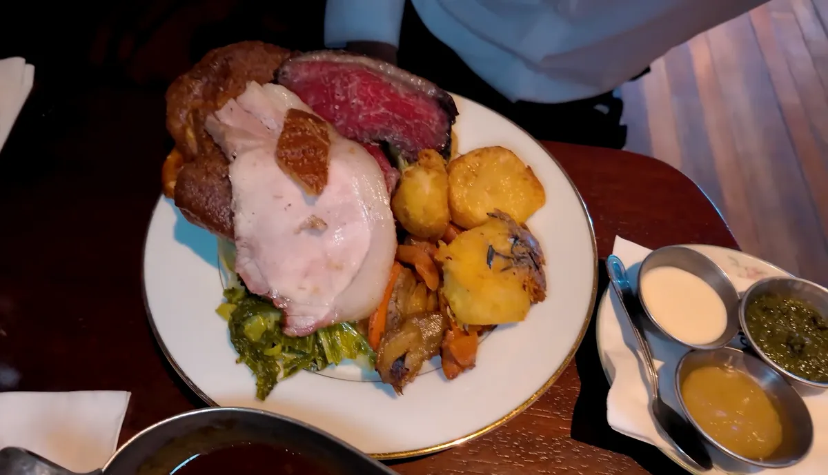Black Lock Sunday roast spread with beef rump, pork, lamb, roast potatoes, vegetables, and gravy sauces