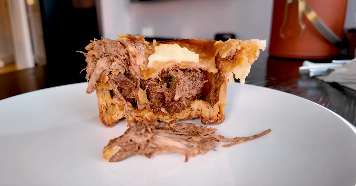The Pie Room braised beef steak pie cross-section showing shredded beef filling in flaky puff pastry