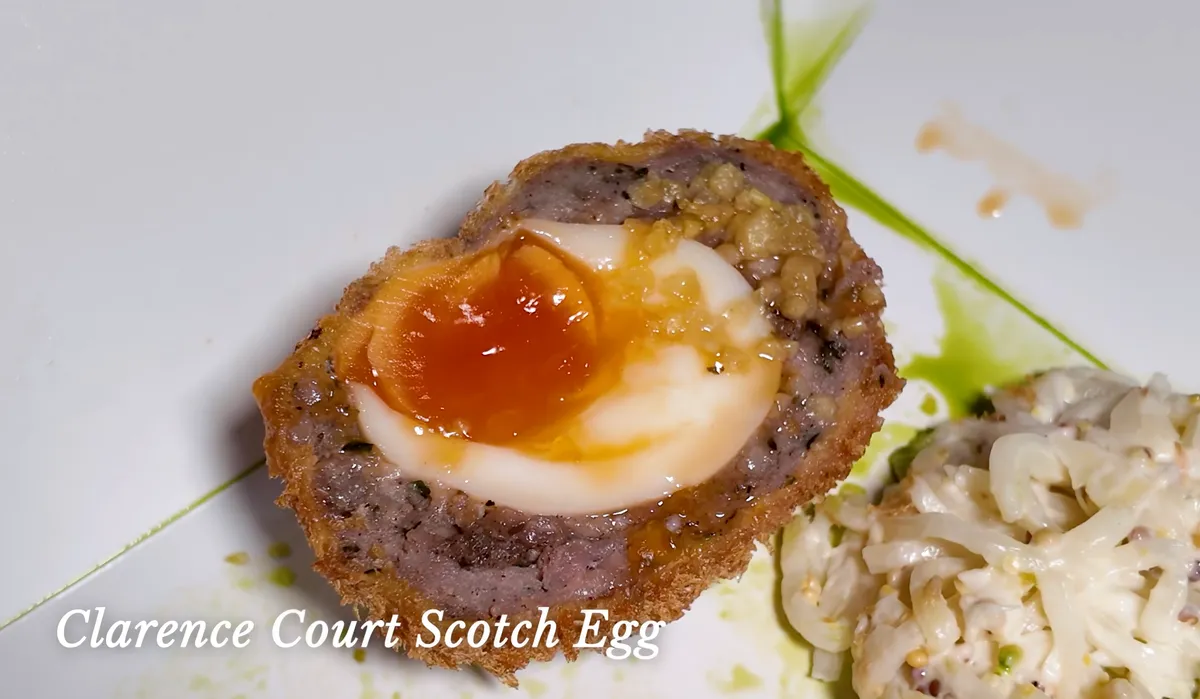 The Pie Room Clarence Court scotch egg cross-section showing jammy yolk and sausage coating