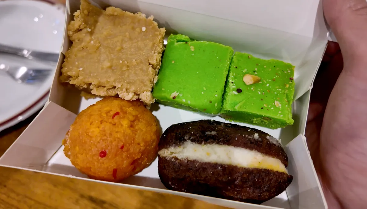 Bengali dessert box with milk cake, pistachio burfi, laddu, and kalakand jamun