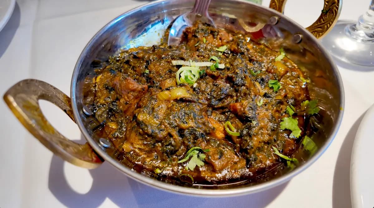 Saag lamb curry in a brass-handled karahi at Eastern Eye, Brick Lane